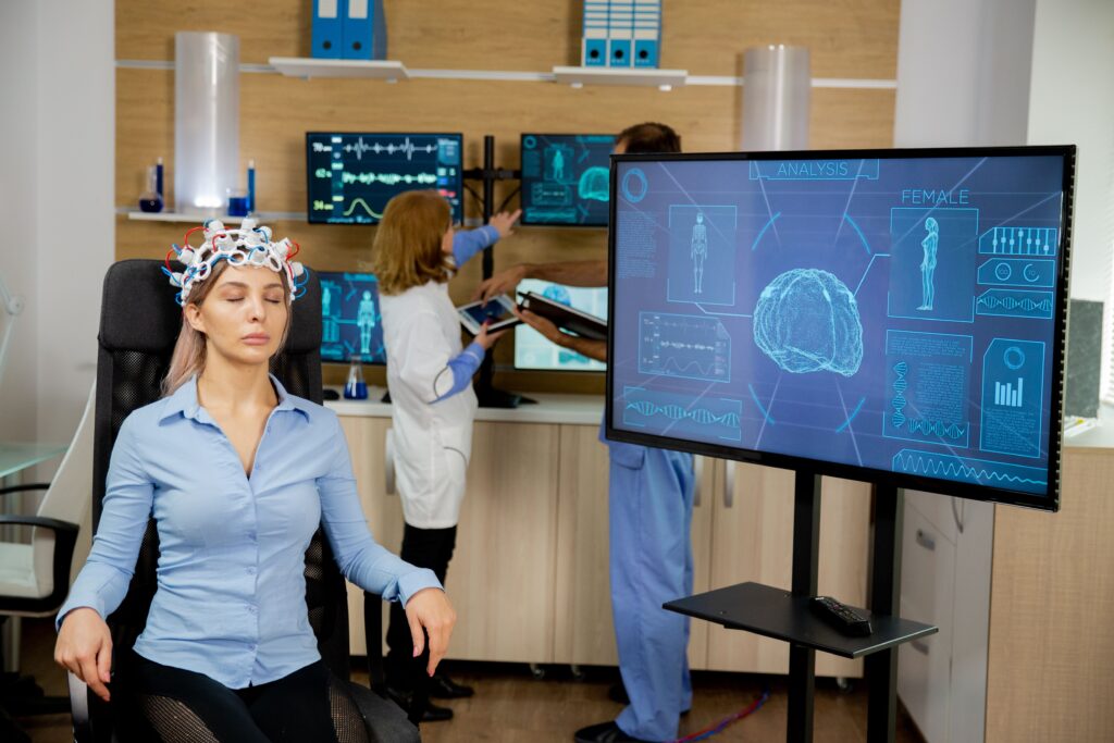 Image showing office workers wearing Brain-Computer Interfaces (BCIs) headsets to monitor brain activity and boost productivity