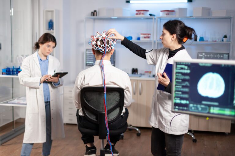 image of Electroencephalography (EEG) setup with electrodes placed on a person’s scalp to measure brainwave activity.